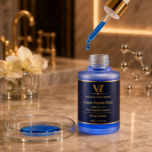 Copper Peptide Elixir dropper releasing a blue serum droplet into the open bottle — water-light texture